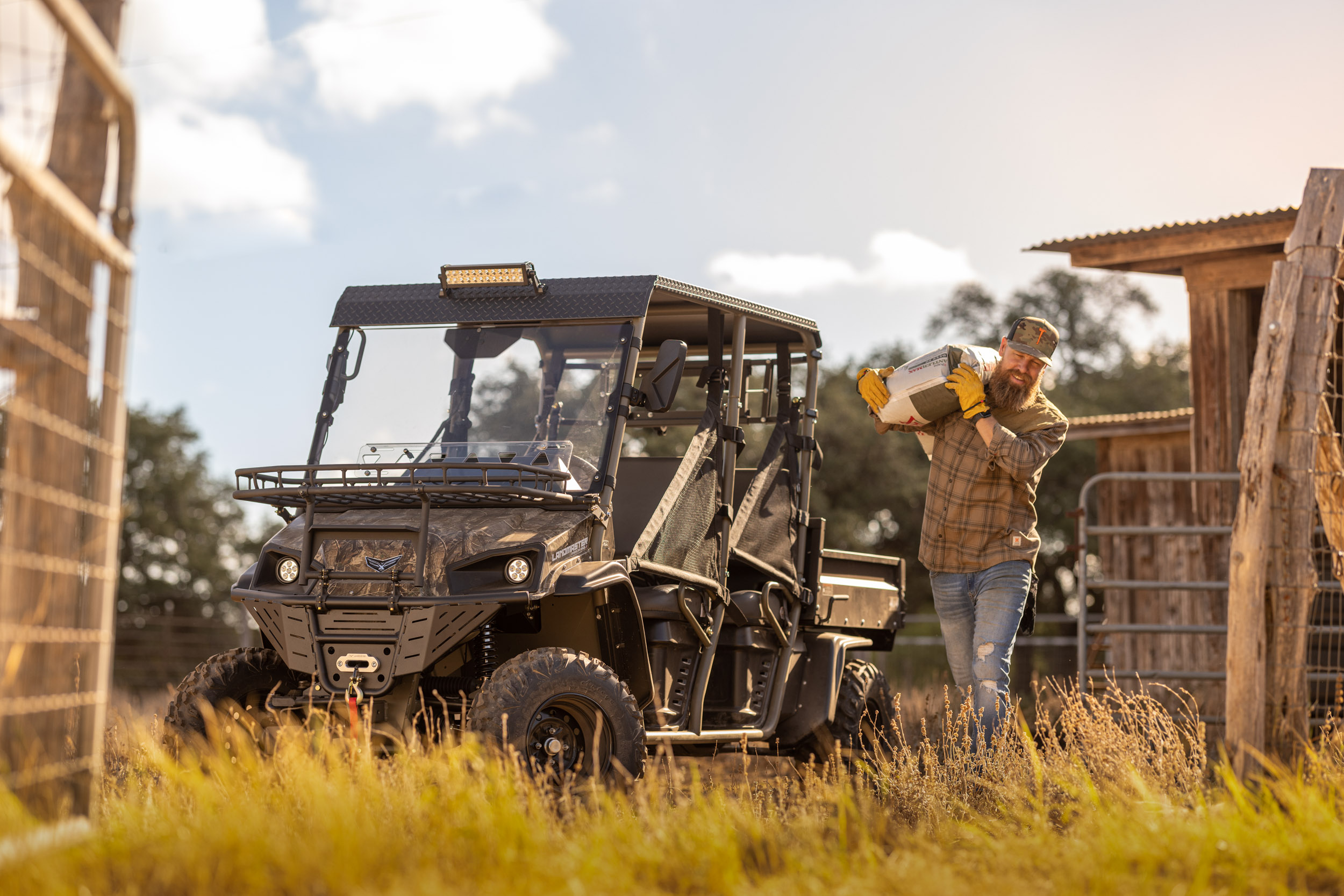 Man loading bag into back of utv on texas ranch