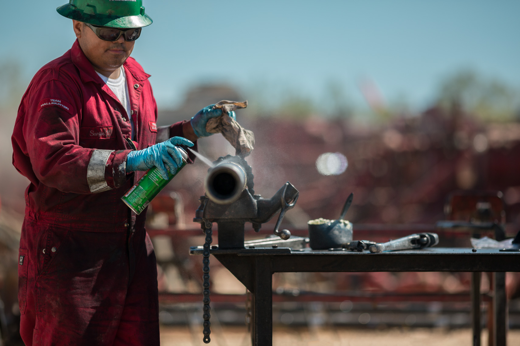 Lifestyle Photo Of Oil & Gas Worker Spraying Pipe by Jason Risner Photography