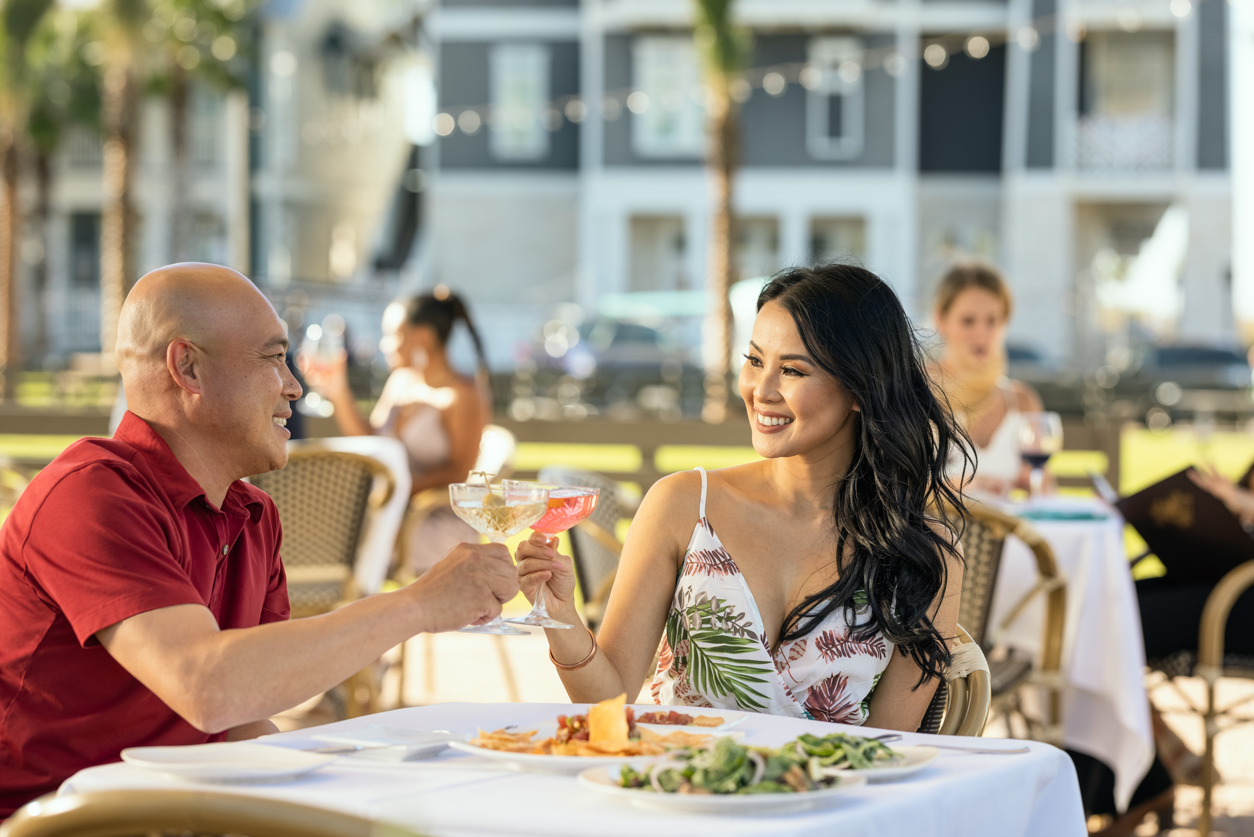 couple having dinner at restaurant outdoor patio in beach community