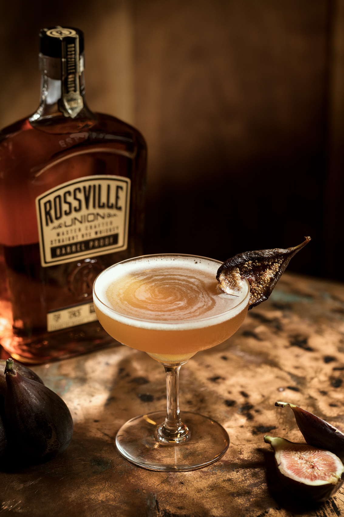 whiskey cocktail in coupe glass with rossville union bottle
