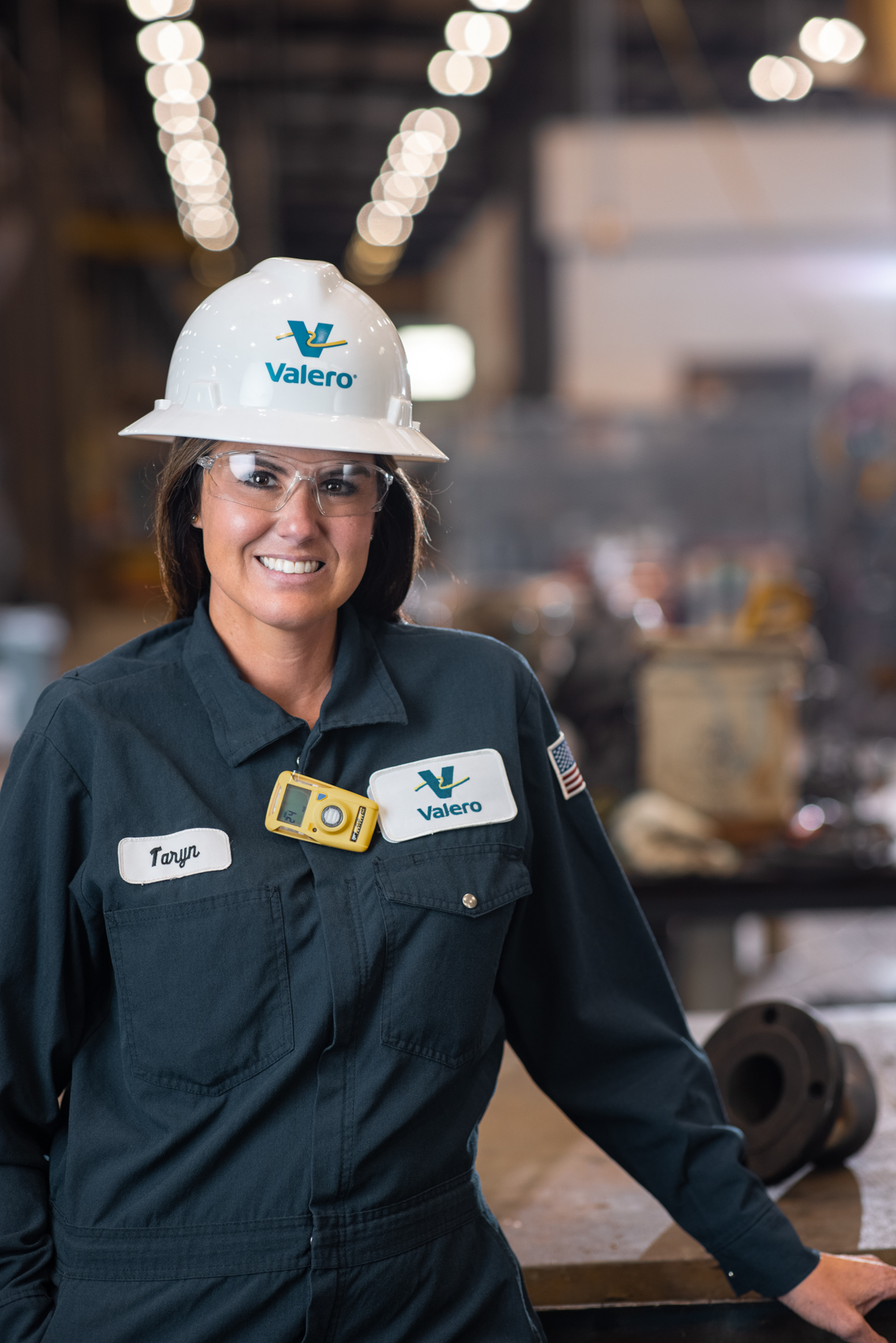industrial worker female wearing hard hat and smiling
