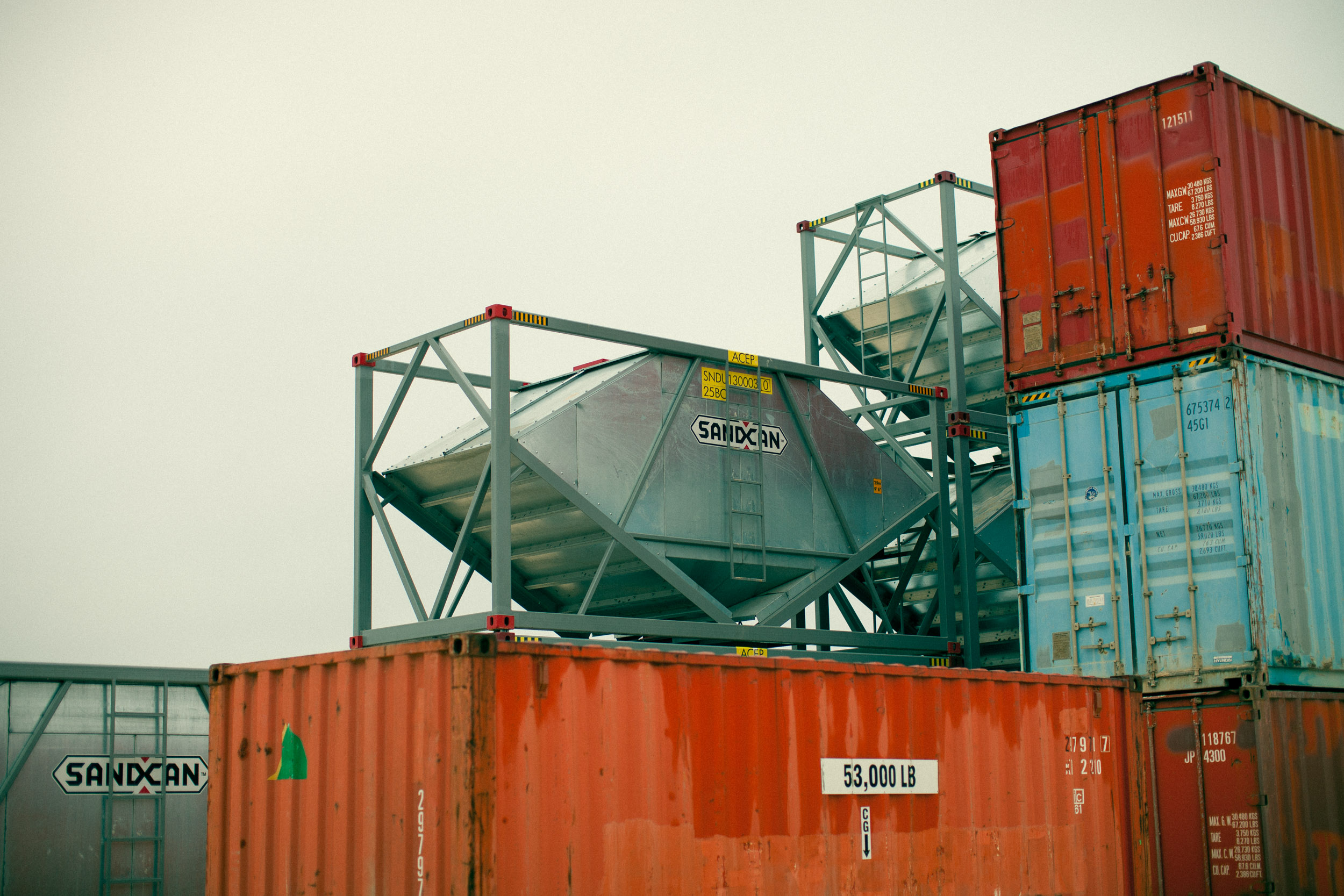 stacks of railroad containers and sand can