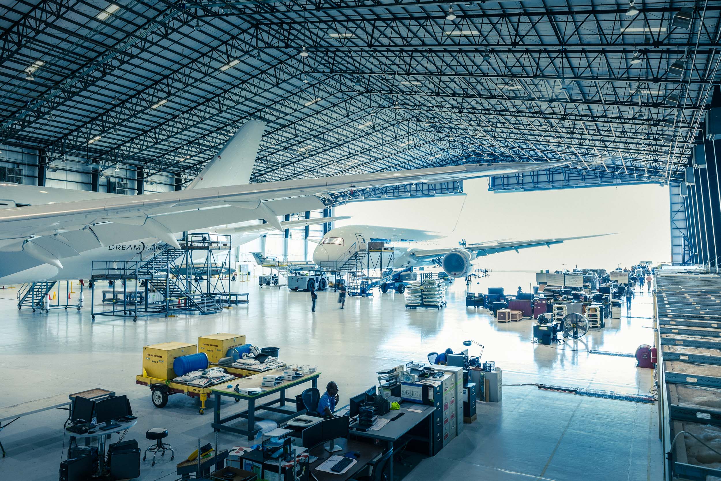 wide view of two airplanes in airplane repair hangar