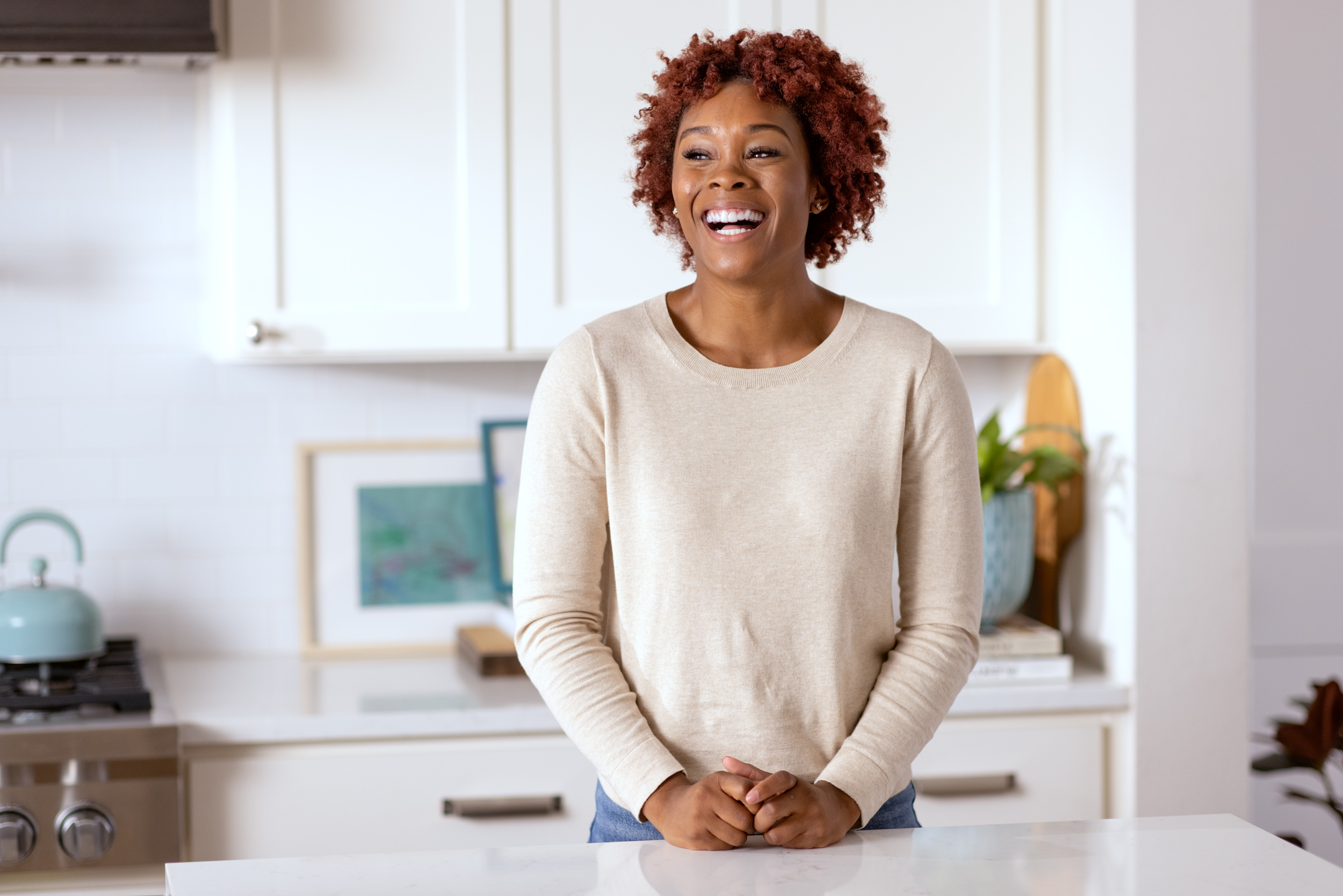 woman standing in kitchen smiling