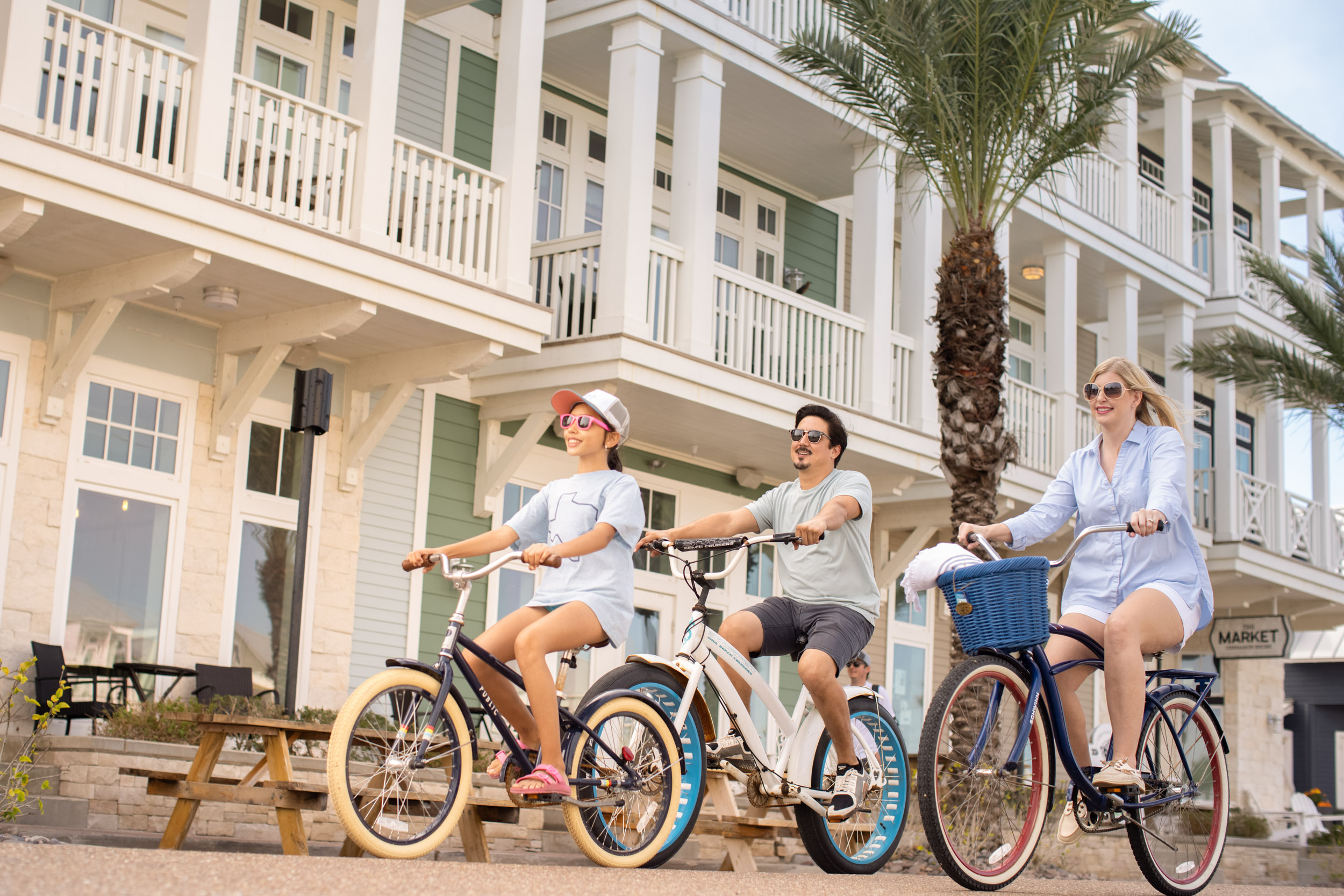 young family riding bicycles at port aransas beach community