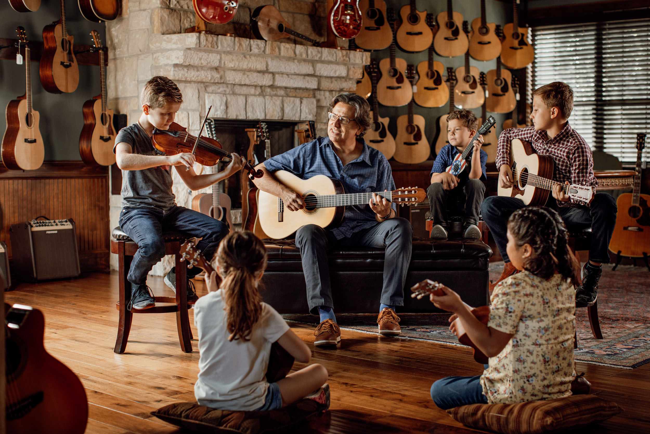 guitar instructor and group of young students at guitar store in boerne texas