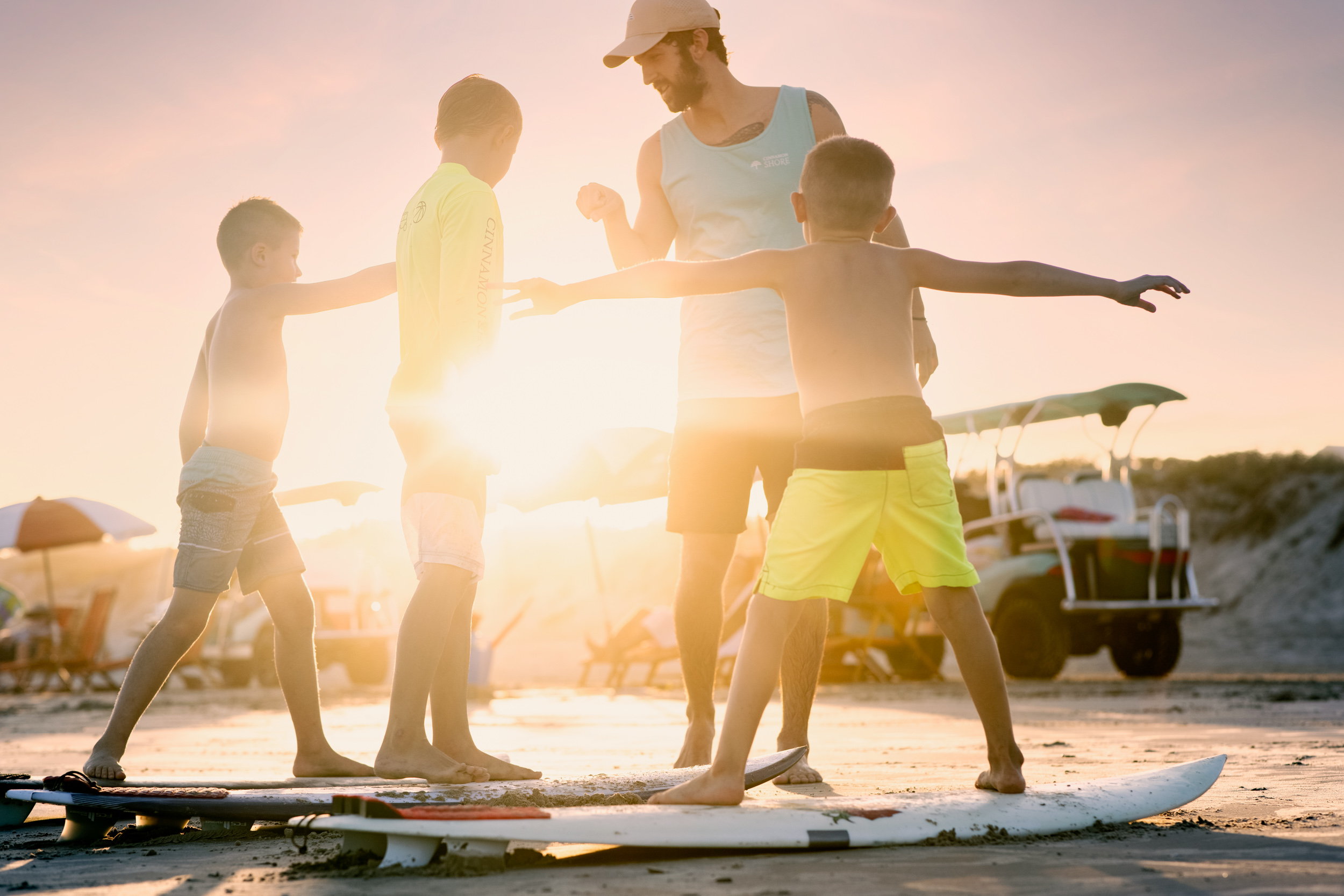 surf instructor fist bumping students at sunset in port aransas