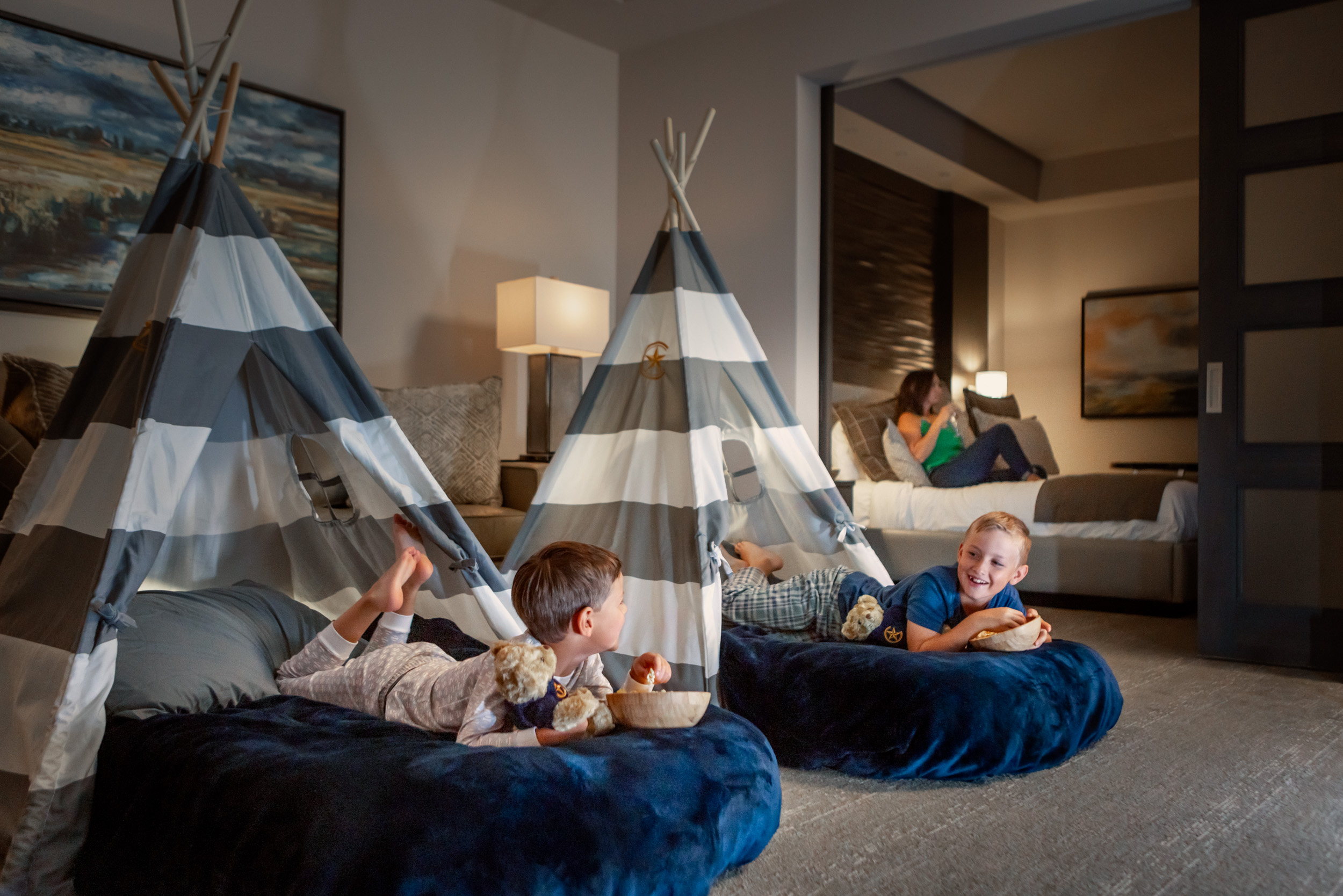 two boys having sleepover with tepees in room