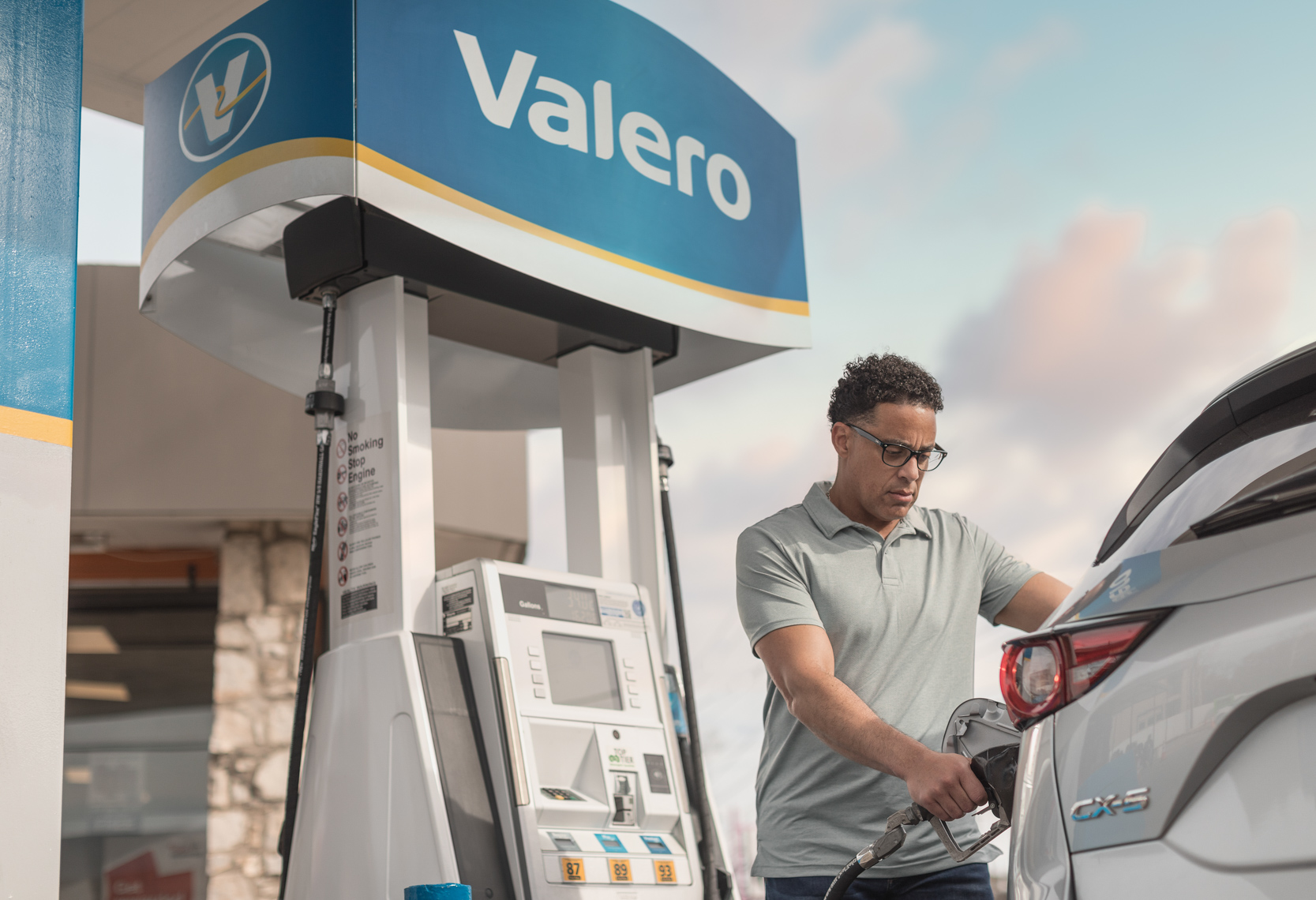Man Pumping  Gas at Valero Gas Station Photographed by Jason Risner 